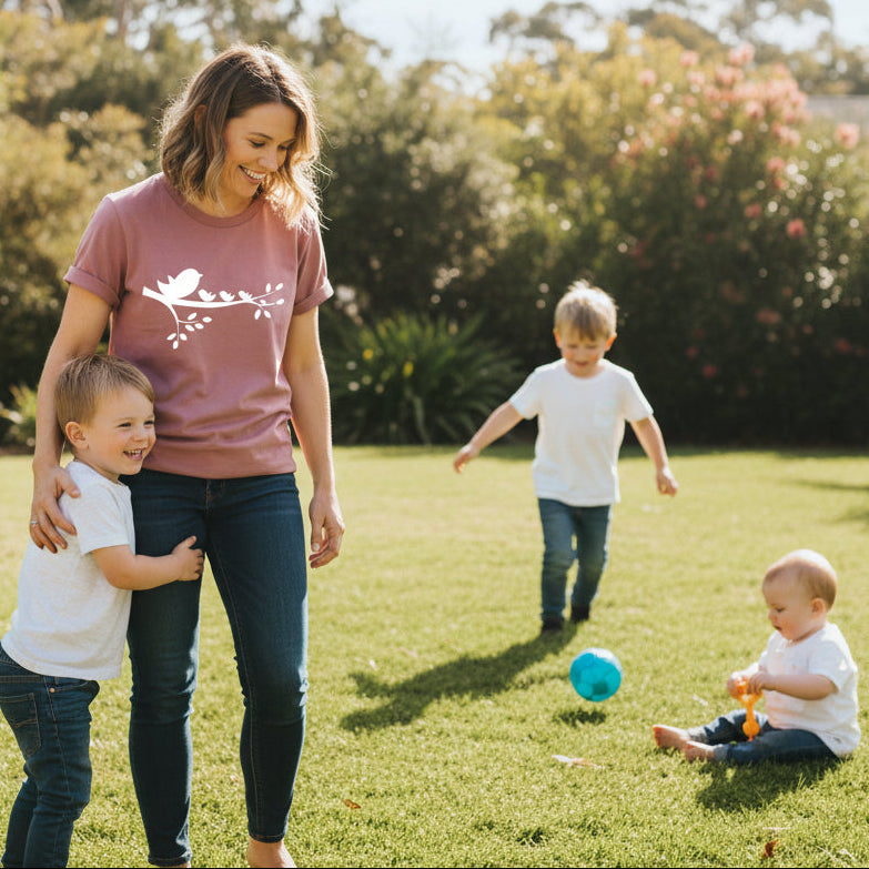 Mother wearing personalised birds on branch t-shirt with children outdoors, custom family bird design representing mum and kids, Mother's Day gift Australia