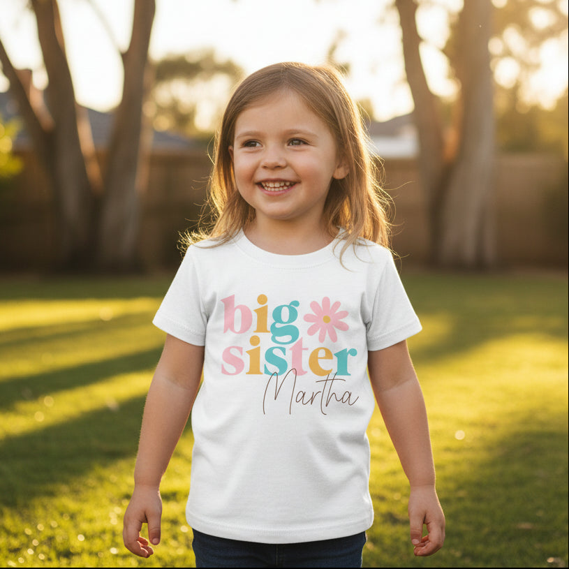 White girls t-shirt with pastel big sister slogan, daisy design and a personalised name.